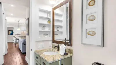 a bathroom with a sink and a mirror at Sea Breeze on 30A in Seacrest