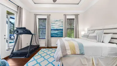 a white bedroom with a large bed and windows at Sea Breeze on 30A in Seacrest
