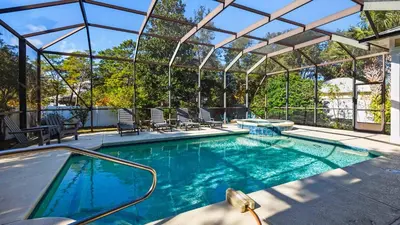 an indoor swimming pool with a pergola and a swimming pool at Sea Breeze on 30A in Seacrest