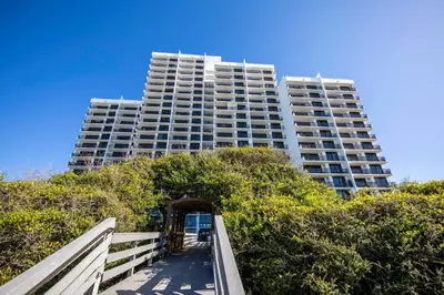 a tall apartment building with a staircase leading up to it at Be Still 30A in Santa Rosa Beach