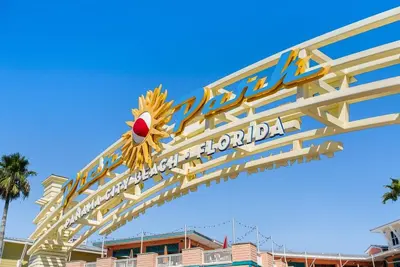a sign at the entrance to the park at the disneyland hotel at Charming house near the beach in Panama City Beach