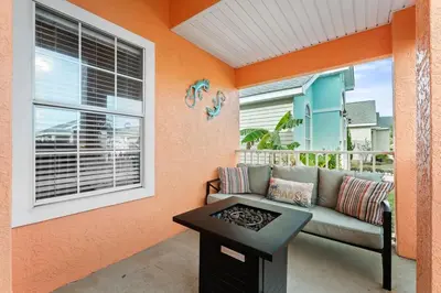 a living room with a couch and a table at Charming house near the beach in Panama City Beach