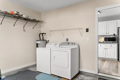 a kitchen with a washing machine in a room at Charming house near the beach in Panama City Beach
