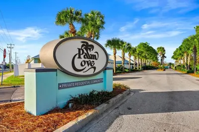 a sign for a palm cove sign with a street at Charming house near the beach in Panama City Beach