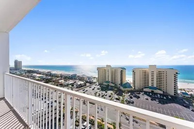 a balcony with a view of the beach and buildings at Beach-Ready Resort Condo! Pools & Walk to Beach by Dolce Vita Getaways in Panama City Beach