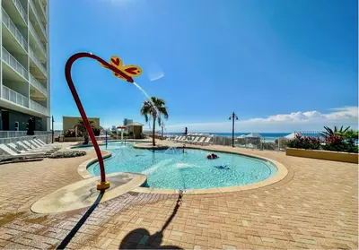 a pool with a fountain in the middle of a building at Beach-Ready Resort Condo! Pools & Walk to Beach by Dolce Vita Getaways in Panama City Beach