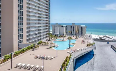 an aerial view of a resort with a swimming pool and the ocean at Beach-Ready Resort Condo! Pools & Walk to Beach by Dolce Vita Getaways in Panama City Beach