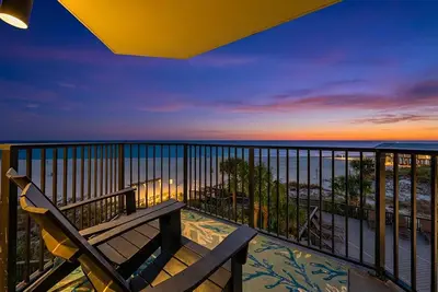 a balcony with a bench and a view of the ocean at Amazing Gulf Views! Resort! Beach Chair Service by Dolce Vita Getaways PCB in Panama City Beach