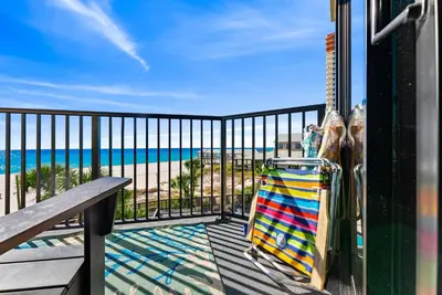 a balcony with a bench and a view of the beach at Amazing Gulf Views! Resort! Beach Chair Service by Dolce Vita Getaways PCB in Panama City Beach
