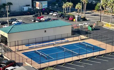 an overhead view of two tennis courts in a parking lot at Amazing Gulf Views! Resort! Beach Chair Service by Dolce Vita Getaways PCB in Panama City Beach