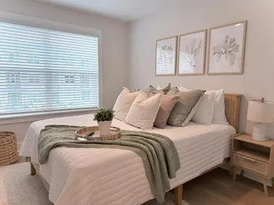 a bedroom with a large bed with a table on it at Coastal Retreat, 1 Mile to Beach, Pool & Golf Cart in Panama City Beach