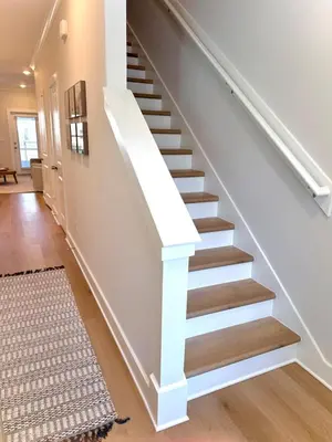 a staircase with white railings and wood treads at Coastal Retreat, 1 Mile to Beach, Pool & Golf Cart in Panama City Beach