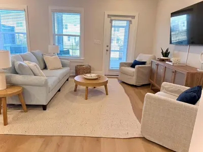 a living room with two couches and a tv at Coastal Retreat, 1 Mile to Beach, Pool & Golf Cart in Panama City Beach