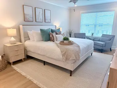 a bedroom with a bed and a couch and a chair at Coastal Retreat, 1 Mile to Beach, Pool & Golf Cart in Panama City Beach