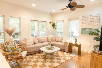 a living room with a couch and a table at Glory Days 30A - Pool, Bikes & Close Beach Access in Inlet Beach