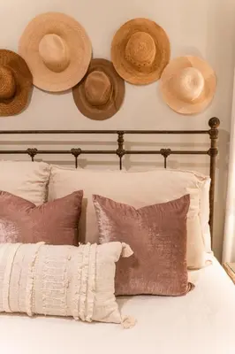 a bed with straw hats on the wall at Glory Days 30A - Pool, Bikes & Close Beach Access in Inlet Beach