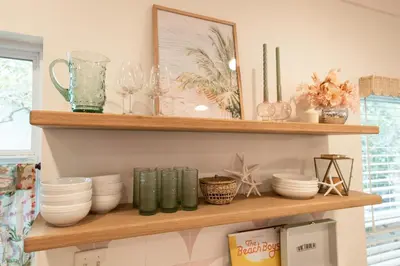 a shelf with bowls and other items on it at Glory Days 30A - Pool, Bikes & Close Beach Access in Inlet Beach