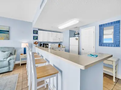 a kitchen and dining room with a long counter top at Majestic Beach Towers 1-1906 in Panama City Beach