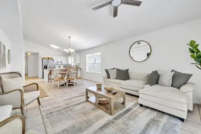 a living room with a couch and a table at Barefoot Villa in Panama City Beach