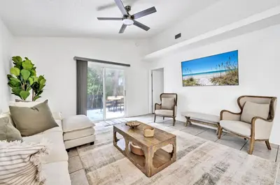 a living room with a couch and a table at Barefoot Villa in Panama City Beach