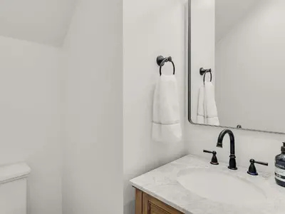 a white bathroom with a sink and a mirror at Elegant 5BR 30A Home w Hot tub & Pool in Santa Rosa Beach