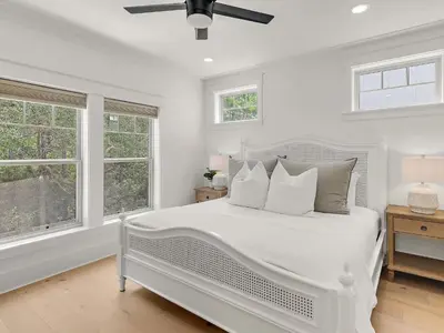 a white bedroom with a white bed and windows at Elegant 5BR 30A Home w Hot tub & Pool in Santa Rosa Beach