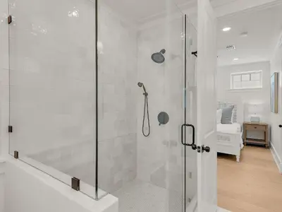a shower with a glass door in a bathroom at Elegant 5BR 30A Home w Hot tub & Pool in Santa Rosa Beach
