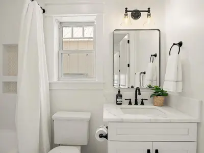a white bathroom with a sink and a mirror at Elegant 5BR 30A Home w Hot tub & Pool in Santa Rosa Beach