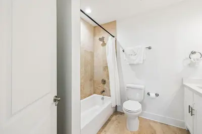 a bathroom with a toilet and a tub and a sink at Sea La Vie on 30A in Rosemary Beach