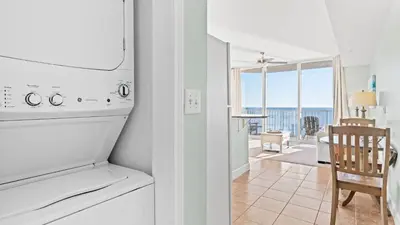 a kitchen and dining room with a view of the ocean at Beachfront Tidewater Resort Condo w Pools Hot Tubs Pier Park Nearby Tidewater Beach by AvantStay in Panama City Beach