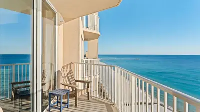 a balcony with chairs and a view of the ocean at Beachfront Tidewater Resort Condo w Pools Hot Tubs Pier Park Nearby Tidewater Beach by AvantStay in Panama City Beach