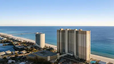 an aerial view of a beach with buildings and the ocean at Beachfront Tidewater Resort Condo w Pools Hot Tubs Pier Park Nearby Tidewater Beach by AvantStay in Panama City Beach