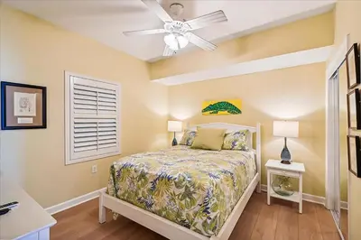 a bedroom with a bed and a ceiling fan at Seychelles 602 by Emerald Coast Retreats in Panama City Beach