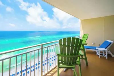 a balcony with two chairs and the ocean at Emerald Beach 1628 by Emerald Coast Retreats in Panama City Beach