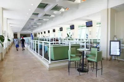 a lobby with a table and chairs in a building at Emerald Beach 1628 by Emerald Coast Retreats in Panama City Beach
