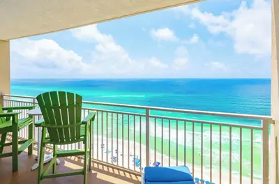 a balcony with two chairs and the ocean at Emerald Beach 1628 by Emerald Coast Retreats in Panama City Beach