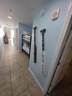 a door with two baseball bats on a wall at Beautiful gulf front condo with grill on balcony in Panama City Beach
