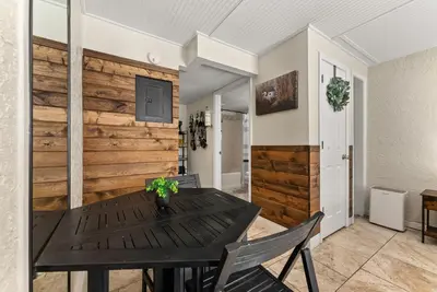 a dining room with a wooden wall at The Ambassador - Unit C5 - Studio King - On Pool Deck in Panama City Beach