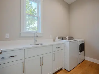 a white kitchen with a sink and a dishwasher at Coastal Breeze in Panama City Beach
