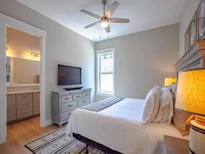 a bedroom with a bed and a flat screen tv at Coastal Breeze in Panama City Beach