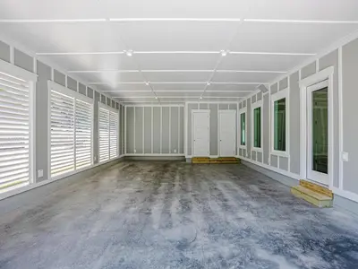 an empty room with white walls and windows at Coastal Breeze in Panama City Beach