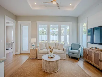 a living room with a couch and a tv at Coastal Breeze in Panama City Beach