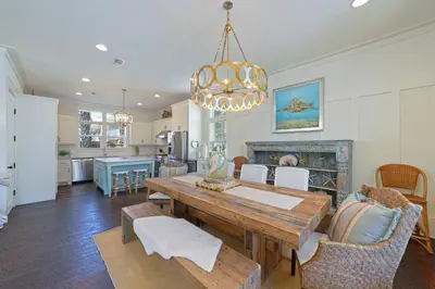 a kitchen and dining room with a table and chairs at Driftwood - Vacation Home Near the Beach with a Large Outdoor Area in Santa Rosa Beach