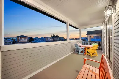 a balcony with two benches and a table with a view at Endless Summer Dream - Cottage Near the Beach with Shared Pool Access in Seacrest