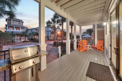 a screened porch with a grill on a house at Endless Summer Dream - Cottage Near the Beach with Shared Pool Access in Seacrest