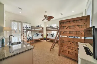 a kitchen with bunk beds and a living room with a sink at Endless Summer Dream - Cottage Near the Beach with Shared Pool Access in Seacrest