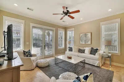 a living room with a couch and a ceiling fan at Endless Summer Dream - Cottage Near the Beach with Shared Pool Access in Seacrest