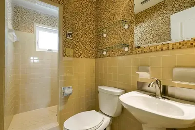 a bathroom with a toilet and a sink at Gulf Escape - 30A Beach House Near the Beach with a Large Pool Space in Inlet Beach