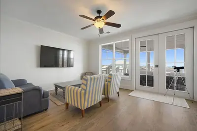 a living room with a couch and a ceiling fan at Hermosa Manor - Luxury Vacation Rental House Near the Beach with Private Pool Area & Gulf Views in Santa Rosa Beach