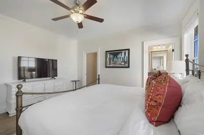 a white bedroom with a bed and a ceiling fan at Hermosa Manor - Luxury Vacation Rental House Near the Beach with Private Pool Area & Gulf Views in Santa Rosa Beach